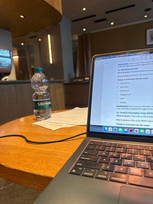 Student studies marketing concepts with laptops in Milan workspace
