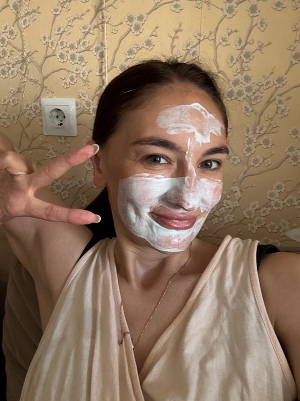 Woman enjoys morning self-care routine with face mask in Sochi