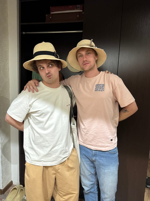 Young men in straw hats pose for photos in Tashkent