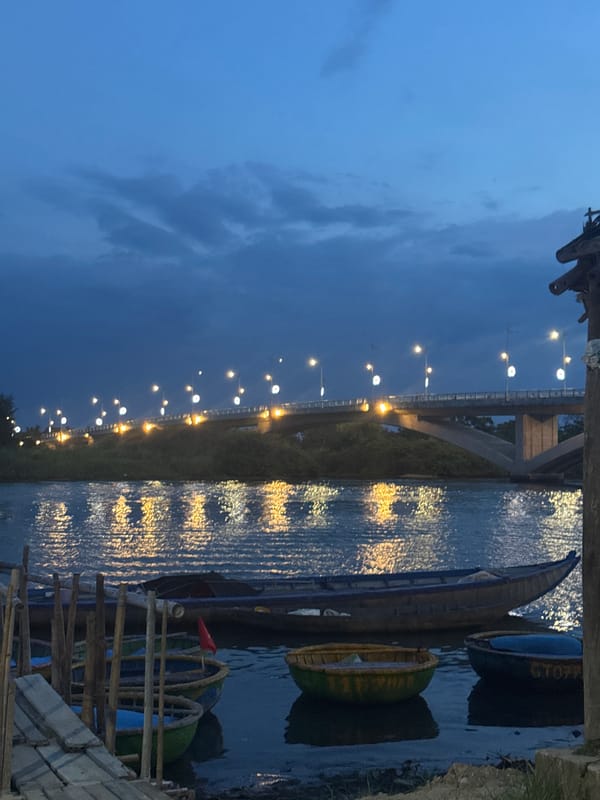 Traditional boats spotted along Đà Nẵng waterway near illuminated bridge