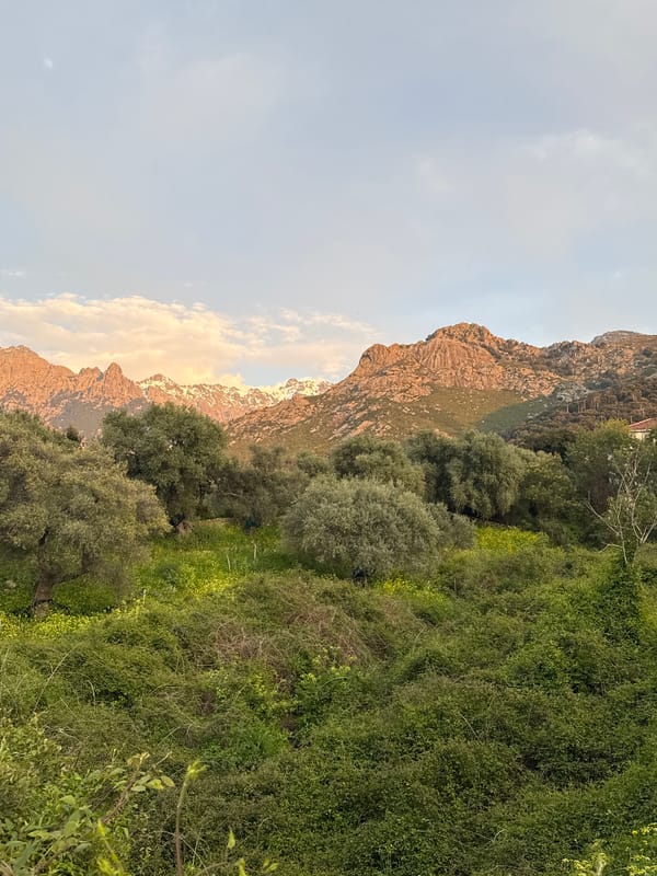 Sunset illuminates snowy peaks in Calenzana mountain landscape