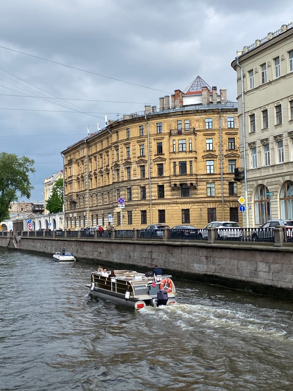 Tour boats navigate Saint Petersburg canals during afternoon sightseeing