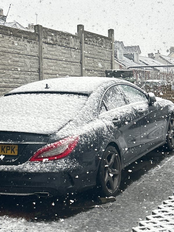 Snow-covered Mercedes parked during heavy Glasgow snowfall