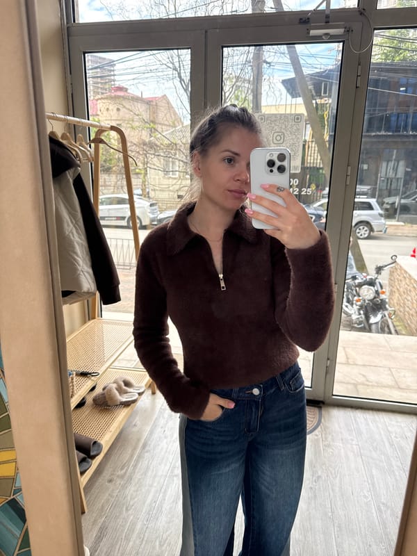 Woman takes mirror selfie in Batumi indoor space