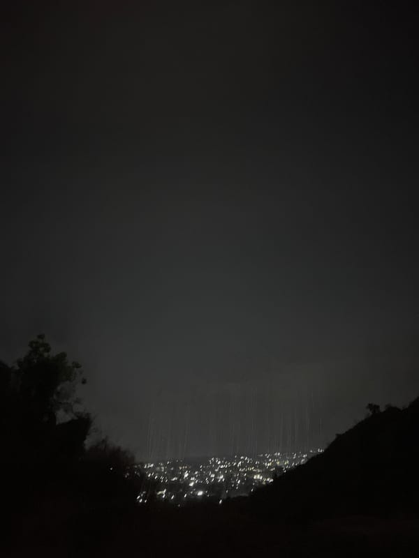 Nighttime aerial view captures Jos city lights from elevated position