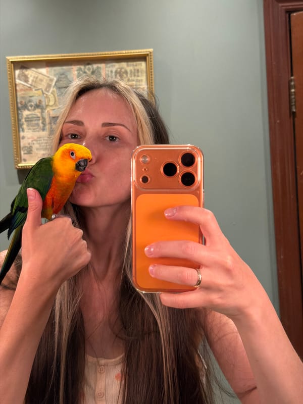 Woman takes selfies with colorful parrot in Khimki bathroom