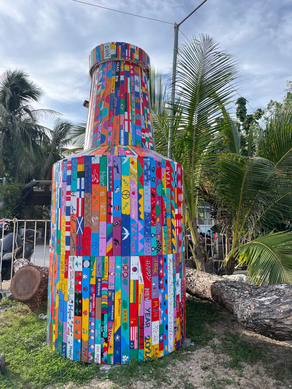 Ban Haad Rin harbor and beaches with blooming flamboyant trees