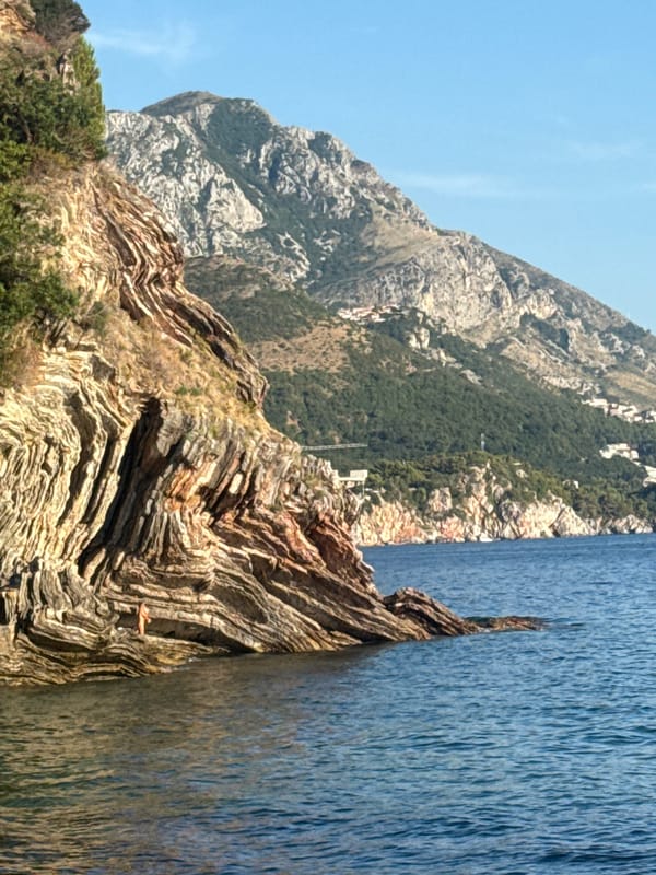 Rocky Adriatic coastline and packed beach, Rafailovići area