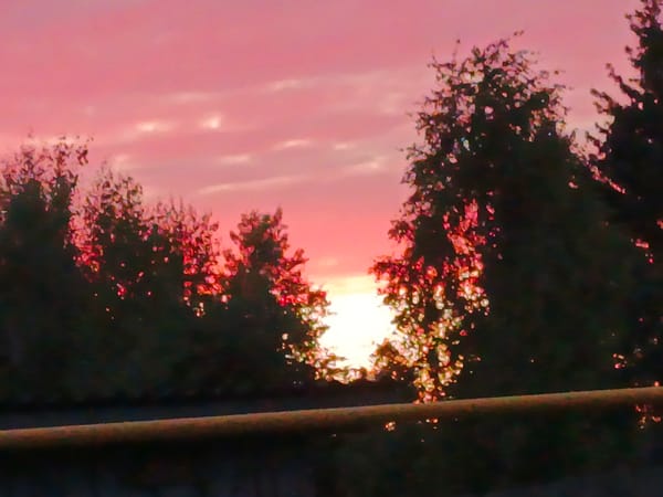 Summer sunset fades across rural roads near Voskresenskoye, Russia