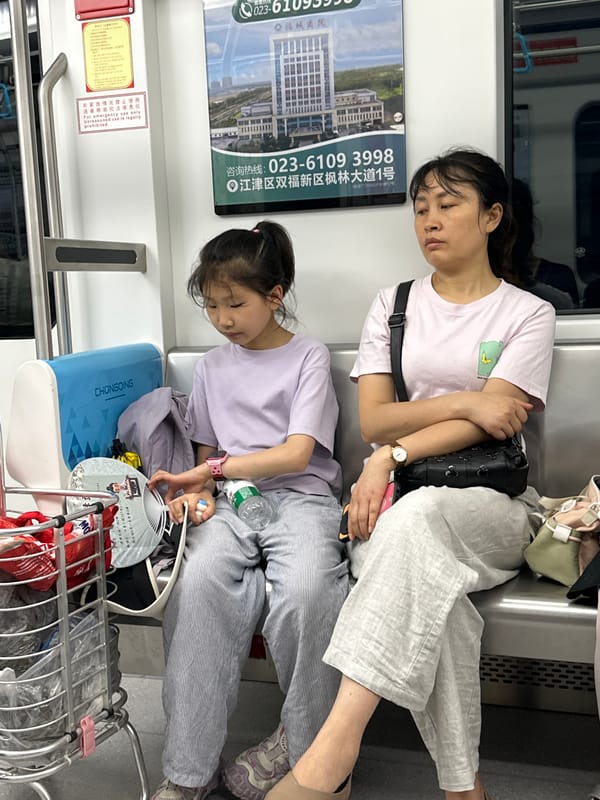 Woman and child sleep on transit in Jiulongpo District