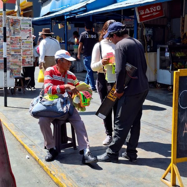 Man sells license plate signs on Arequipa street