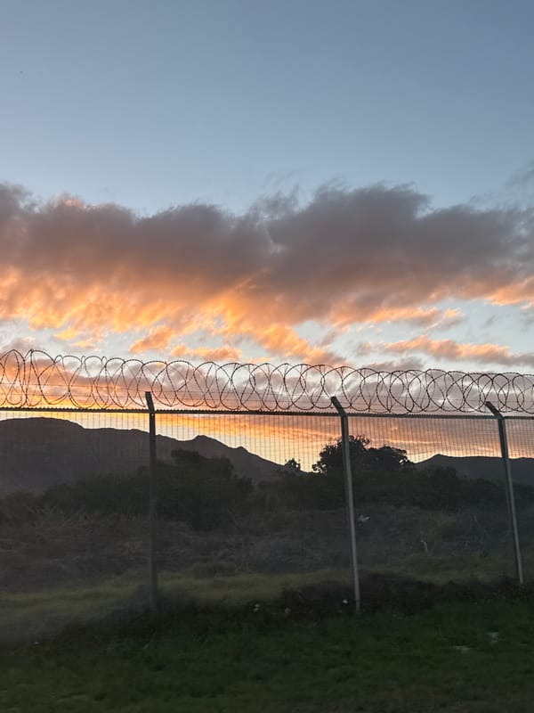 Fenced sunset captured over Cape Town mountains