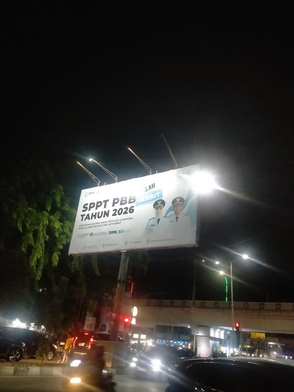 Property tax billboard illuminated at night in Banda Aceh