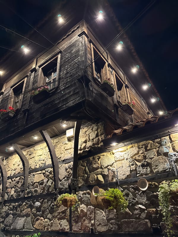 Rustic wooden building and stone wall in nighttime Sozopol
