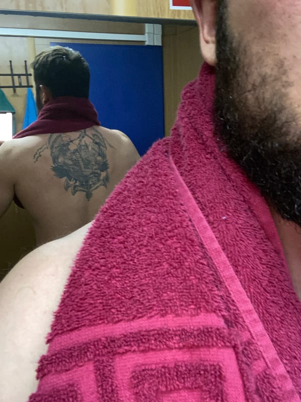 Man documents tattoos in extended bathroom selfie session