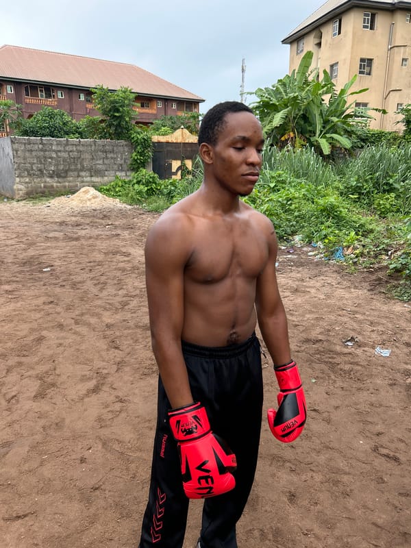 Informal boxing training session on a dirt lot in Ihiagwa