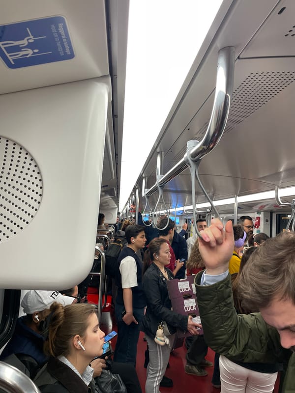 Rush hour commuters fill Milan subway car during evening transit