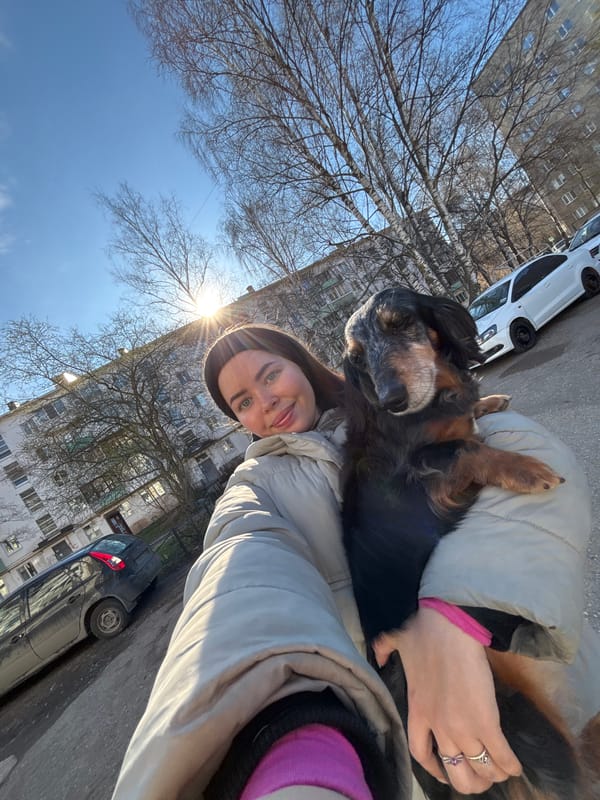 Woman takes sunny day selfie with dog in Izhevsk