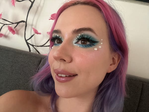 Colorful-haired person photographed with distinctive makeup in Zagreb