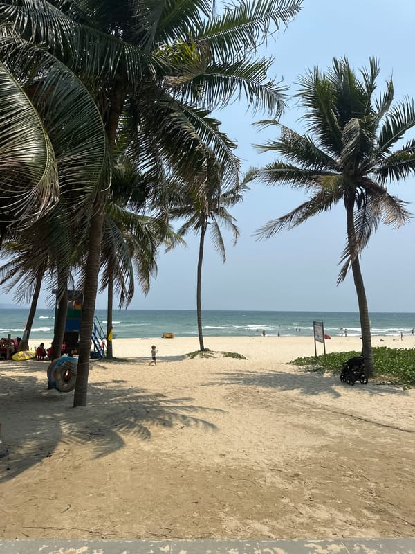 Early morning beach scene with swimmers in Đà Nẵng