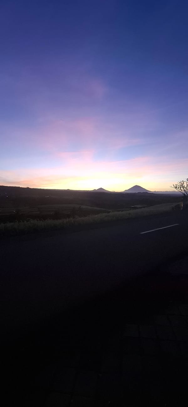 Evening sky gradient observed over terraced mountains in Penebel
