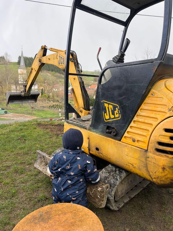 Family yard work day with toddler, corgi, construction equipment