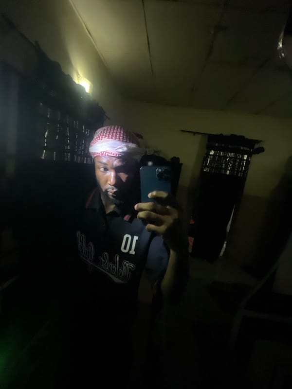 Man in jersey poses for photos in Lokoja home