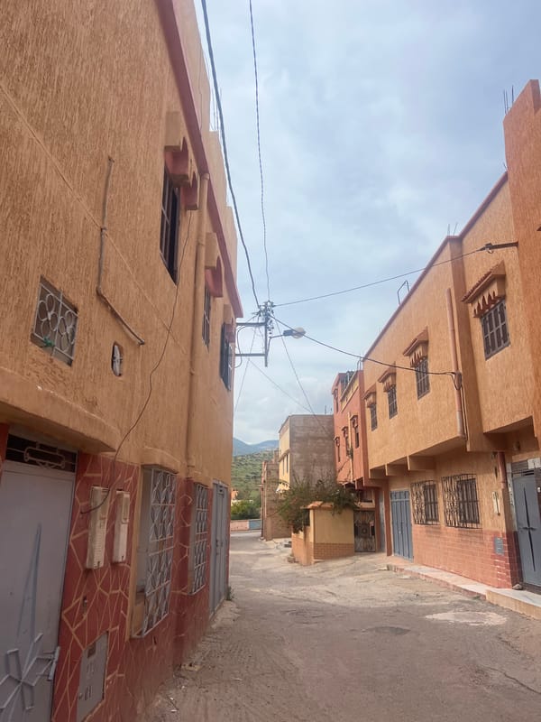 Driver documents street scenes during journey through Ouaouizert, Morocco