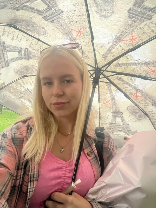 Selfies under an Eiffel Tower umbrella with bouquet in hand