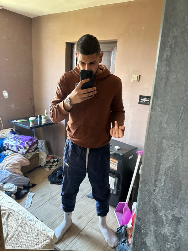 Man takes mirror selfie in Bulgarian home