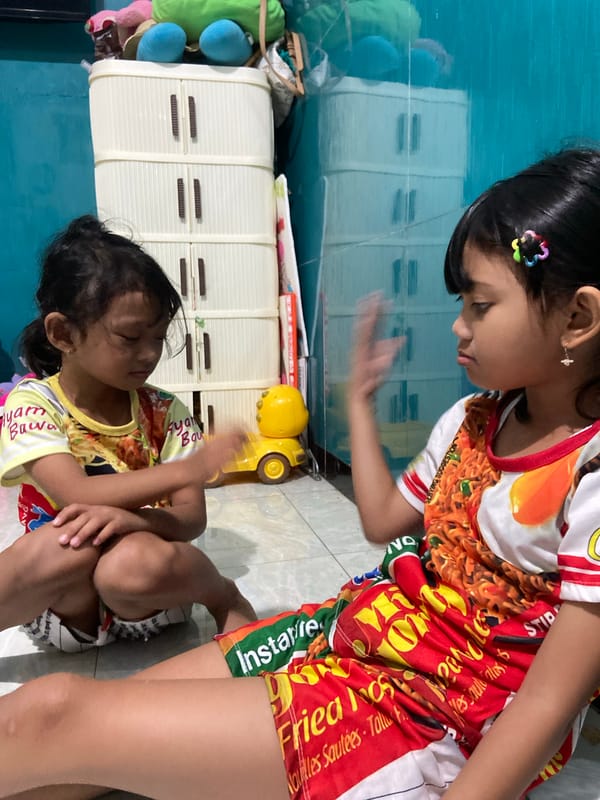 Kids playing games and eating at home in Gelam