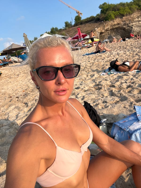 Relaxed beach day with sunbathers on sand and loungers