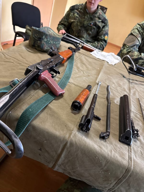 Person in fatigues observed with disassembled AK-47 components