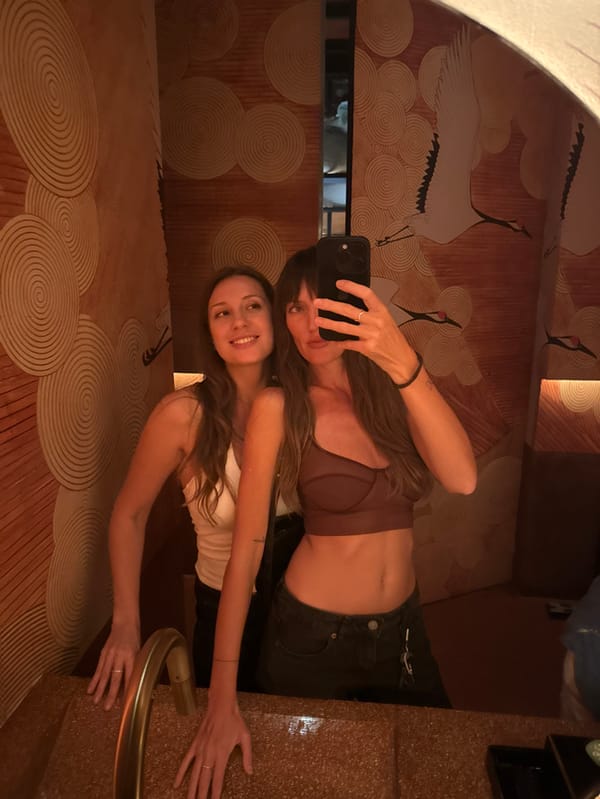 Two women capture mirror selfie in Tibubeneng, Indonesia
