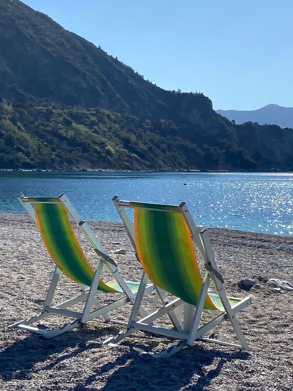 Beach chairs and tables set up on Montenegro coastline