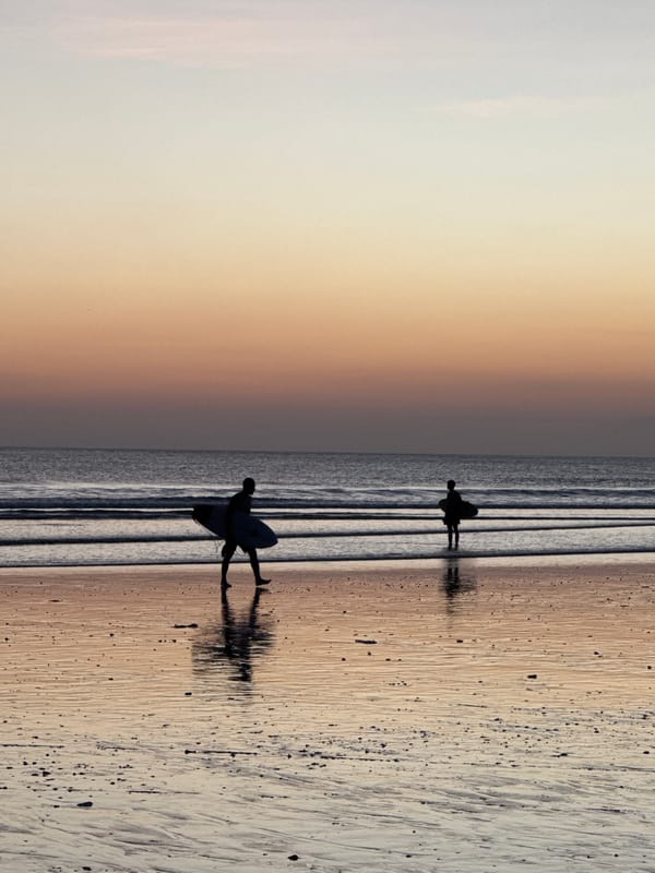 Sunset beach scene with surfers at Kuta Indonesia