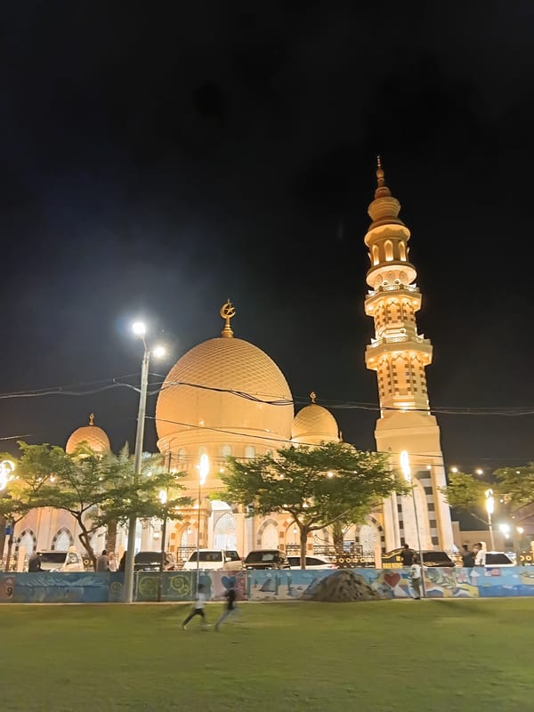 Golden mosque illuminated at night in Banda Aceh