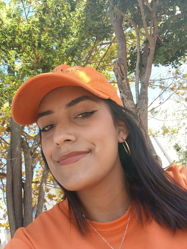 Woman takes selfies among blooming trees in Altagracia, Venezuela