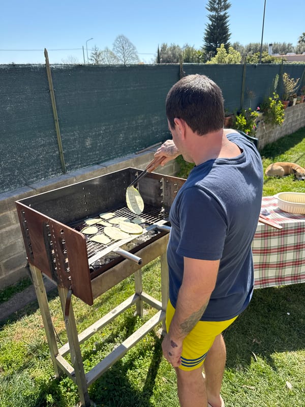 Man meditates with dog amid spring flowers in Aprilia