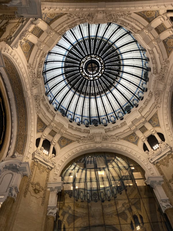 Tourist documents Buenos Aires architectural landmarks during downtown walking tour
