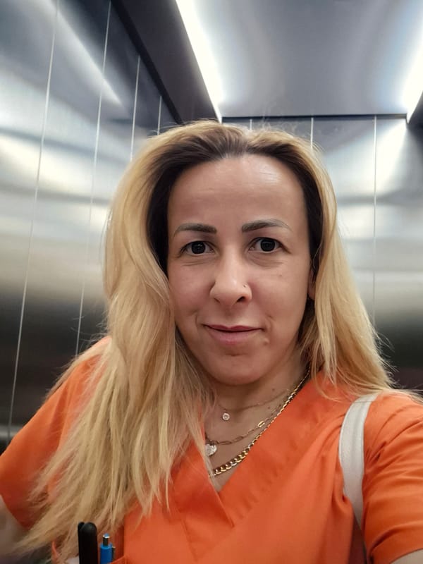 Woman takes selfies near outdoor patio during evening hours