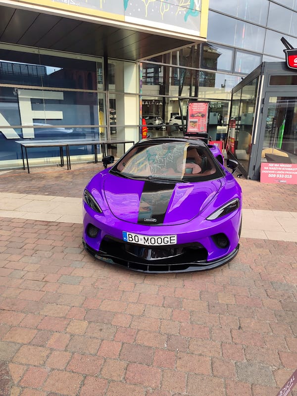 Purple McLaren parked outside Manufaktura complex in Łódź