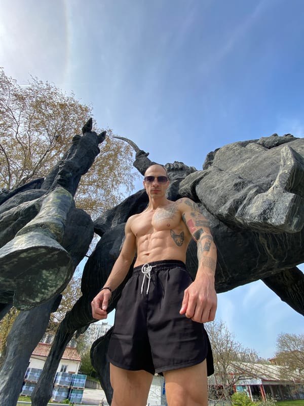 Tourist poses shirtless at Pleven monuments in Bulgaria