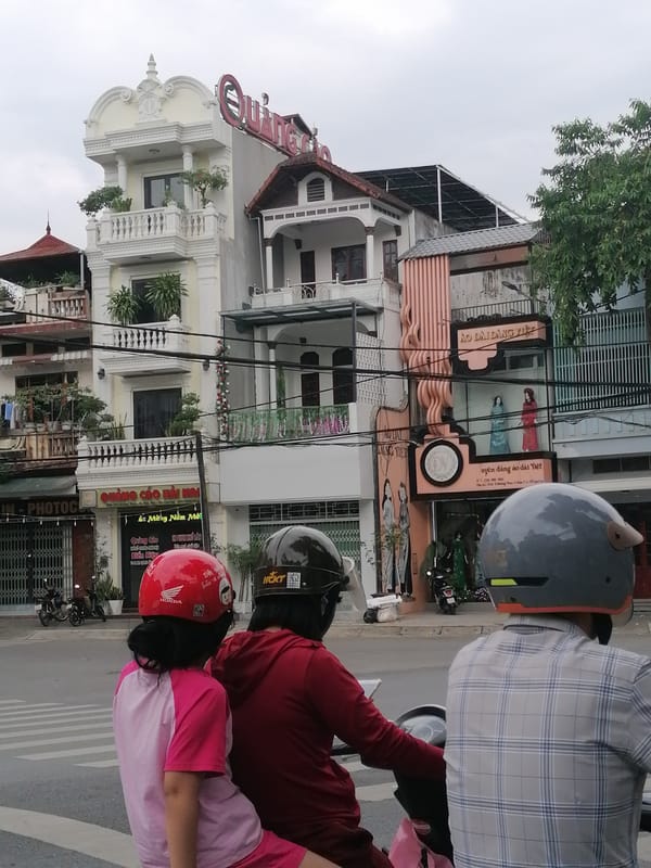 Three people share motorbike ride in Lao Cai Ward