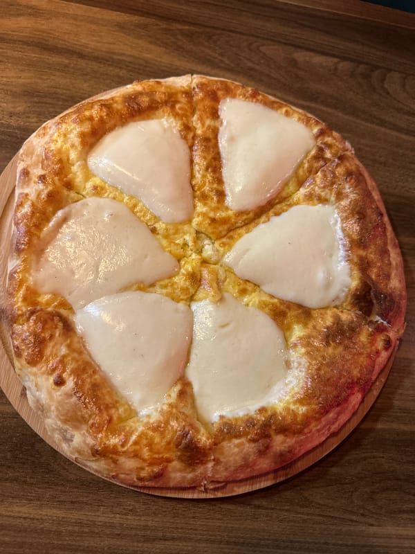 Round cheese-topped dish documented in Zestaponi, Georgia