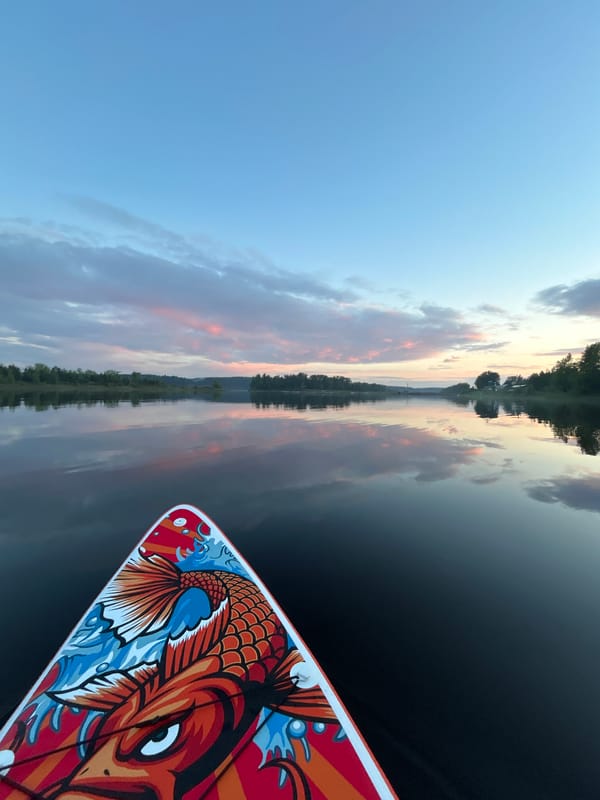 Sunset paddleboarding and camping documented along Noviy Russia waterway