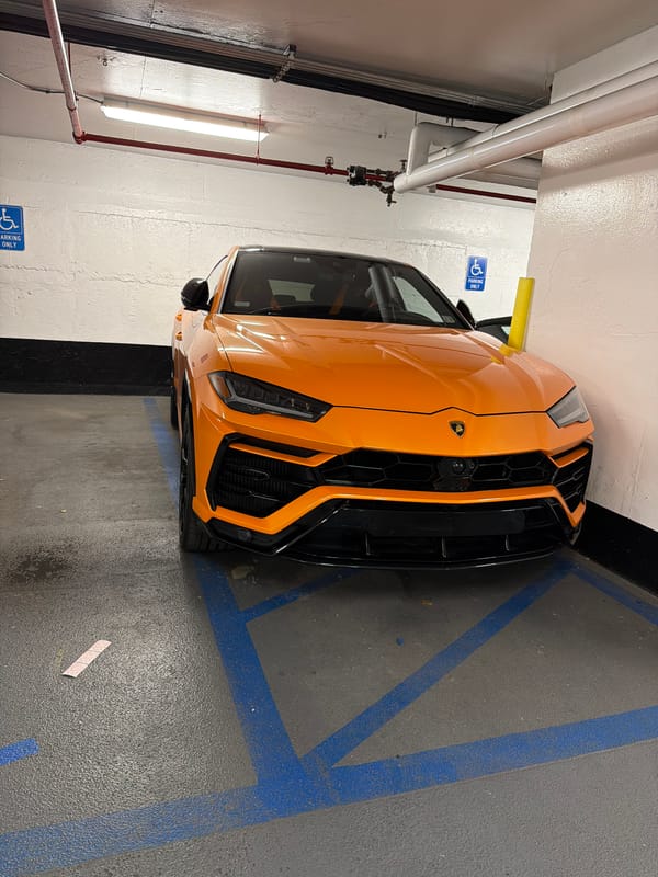 Orange Lamborghini in handicapped spot, Midtown NYC garage