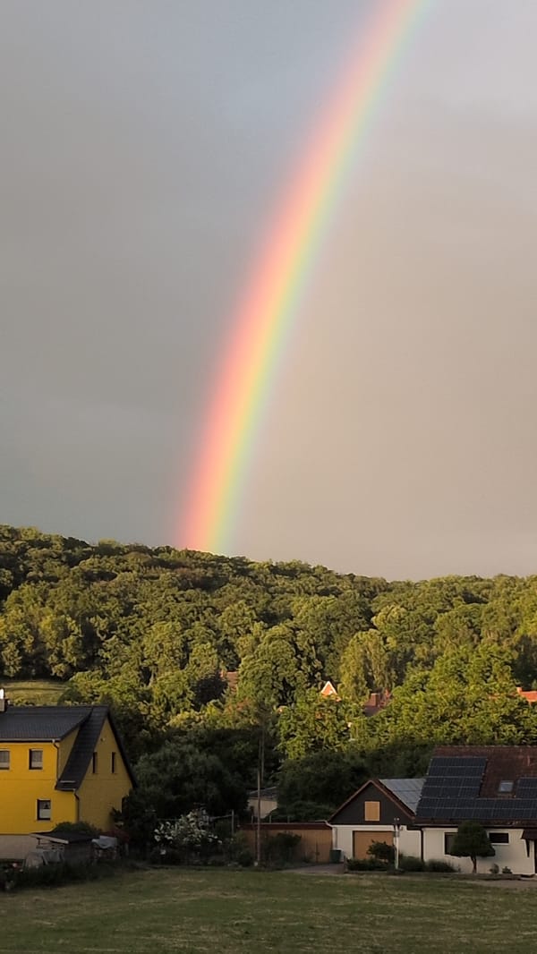 Rainbow over Rastenberg with garden watering and candy bowl