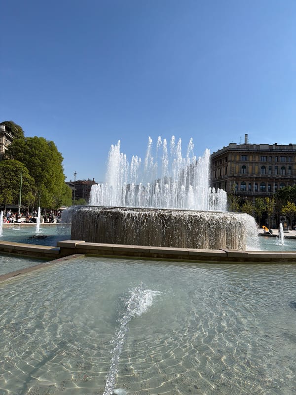 Sunny afternoon crowds gather at Milan's historic center