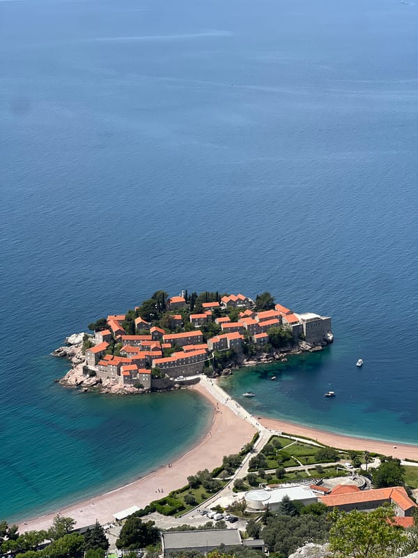 Tourists gather at Sveti Stefan viewpoints on sunny morning